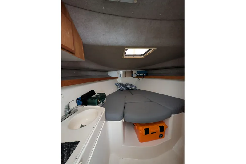 Slide: The Image of 1996 Henriques 28 Express cabin interior with bed, sink, and storage. - 22
