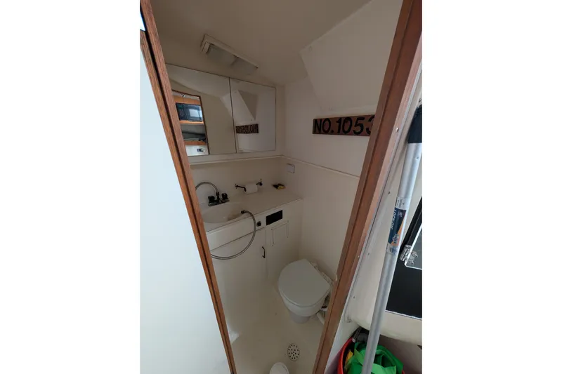 Slide: The Image of Interior of 1996 Henriques 28 Express boat bathroom with sink and toilet. - 26
