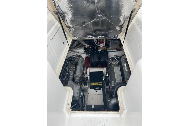 Slide: The Image of Engine compartment of a 1996 Henriques 28 Express boat, featuring Yanmar engines. - 27
