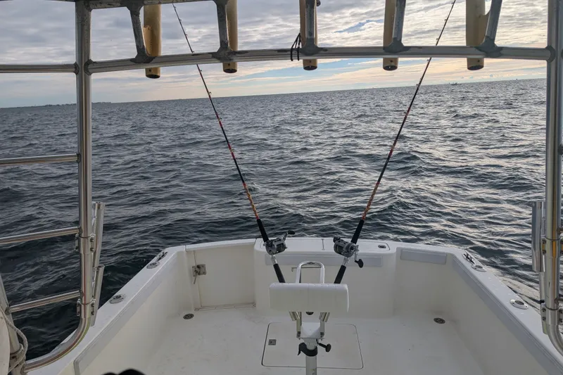 Slide: The Image of 1996 Henriques 28 Express boat with fishing rods on open sea. - 29