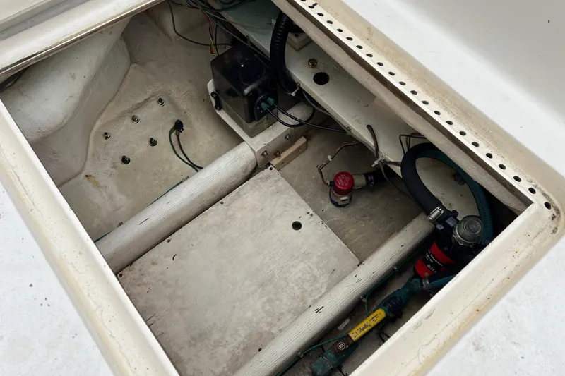 Slide: The Image of 1996 Henriques 28 Express boat interior compartment with wiring and components. - 7
