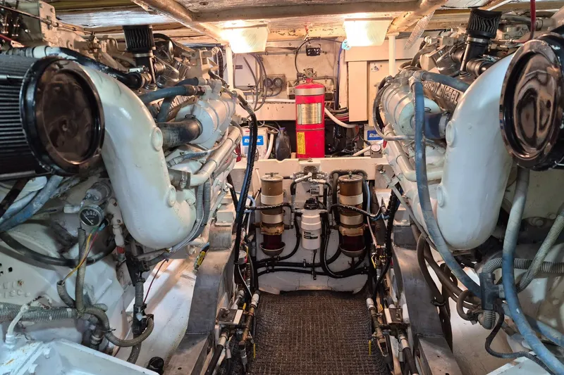 Slide: The Image of Engine room of a 1995 Bertram 43 Convertible yacht, showcasing dual engines and equipment. - 11