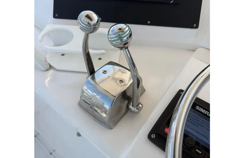 Slide: The Image of Chrome throttle controls on a 1995 Bertram 43 Convertible yacht dashboard. - 9