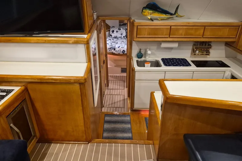 Slide: The Image of Interior of 1995 Bertram 43 Convertible yacht with kitchen and cozy cabin. - 5