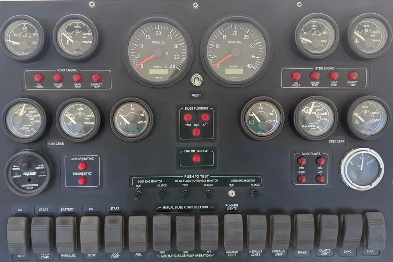Slide: The Image of Control panel of a 1995 Bertram 43 Convertible boat with gauges and switches. - 4