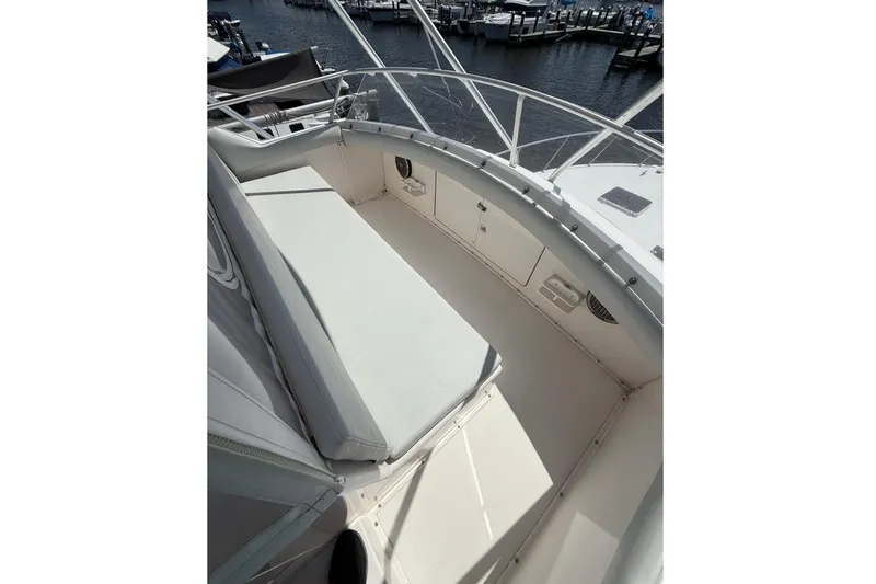 Slide: The Image of 1995 Bertram 43 Convertible boat deck with seating, docked at marina. - 7