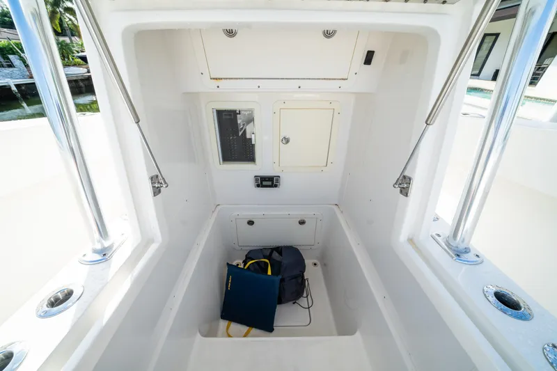 Slide: The Image of 2016 Invincible 36 Open Fisherman boat interior with storage compartment and control panel. - 10