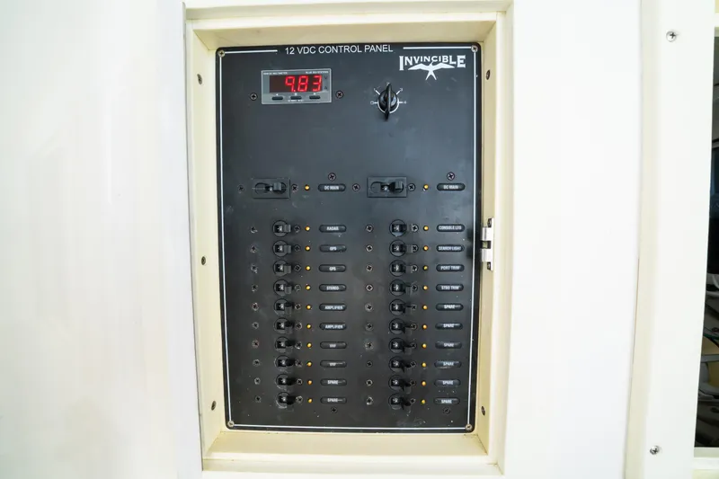 Slide: The Image of Control panel of 2016 Invincible 36 Open Fisherman boat, displaying voltage and switches. - 11