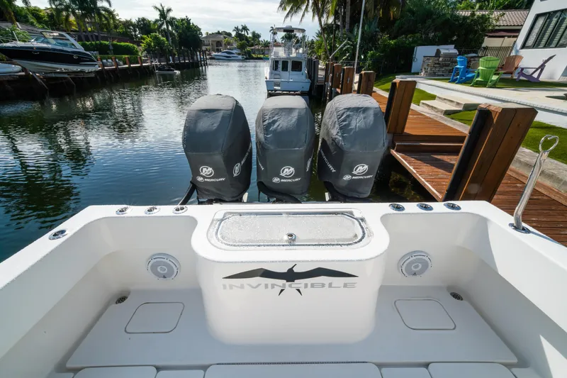 Slide: The Image of 2016 Invincible 36 Open Fisherman with triple Mercury engines docked in a scenic canal. - 20