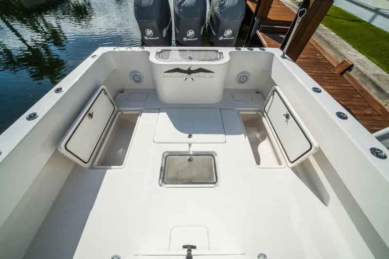 Slide: The Image of 2016 Invincible 36 Open Fisherman boat deck with storage compartments and Mercury engines. - 22