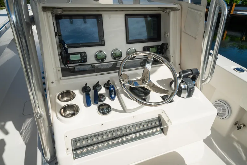 Slide: The Image of Control panel of 2016 Invincible 36 Open Fisherman boat with steering wheel and navigation equipment. - 3