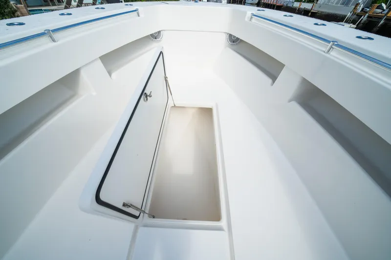 Slide: The Image of 2016 Invincible 36 Open Fisherman boat storage compartment, open hatch view. - 6