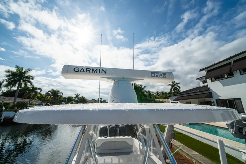 Slide: The Image of 2016 Invincible 36 Open Fisherman with Garmin xHD2 radar, docked by a canal under a sunny sky. - 7