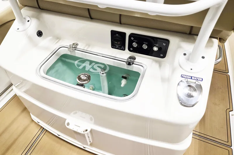 Slide: The Image of 2018 NauticStar 25 XS boat console with livewell and control panel. - 11