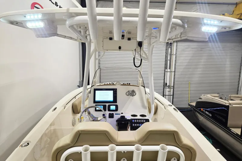 Slide: The Image of 2018 NauticStar 25 XS boat interior with advanced navigation system and LED lighting. - 15