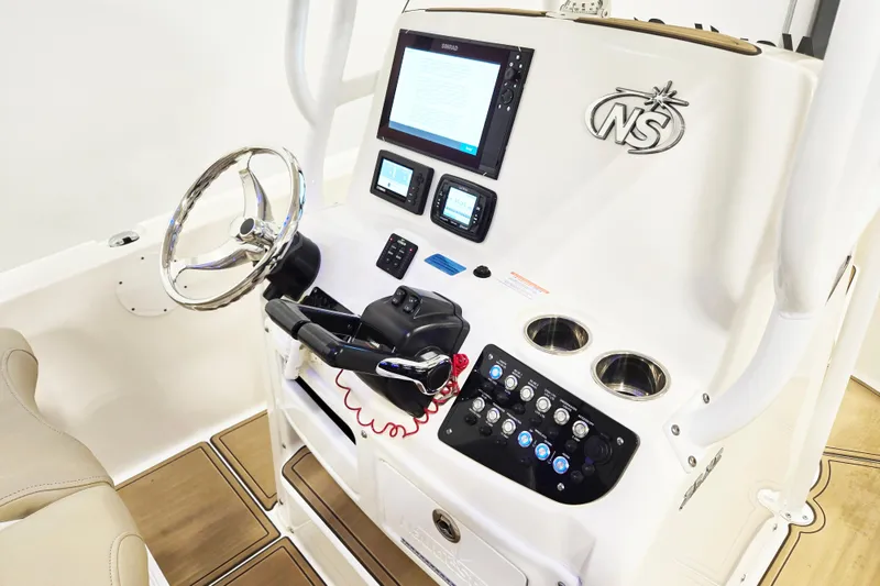 Slide: The Image of 2018 NauticStar 25 XS boat console with steering wheel and control panel. - 16