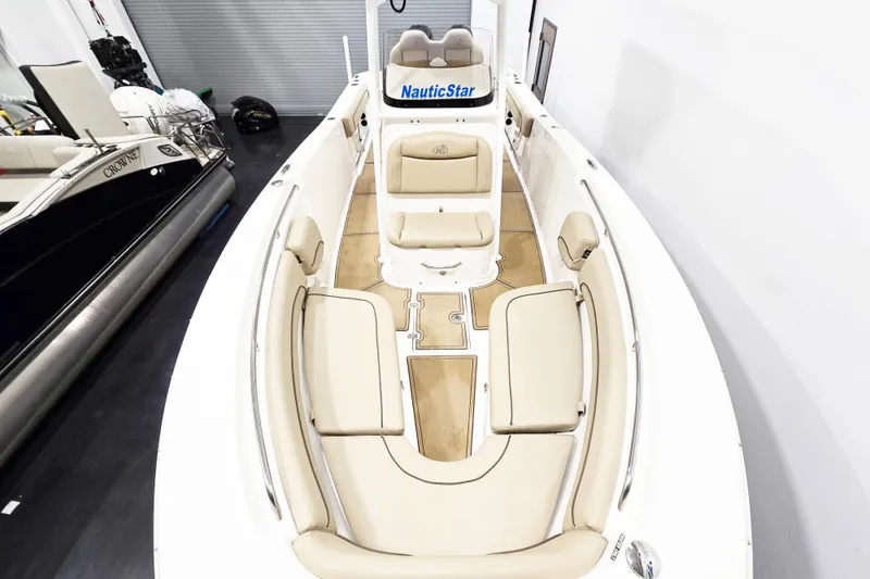 Slide: The Image of 2018 NauticStar 25 XS boat with beige seating and spacious deck. - 18