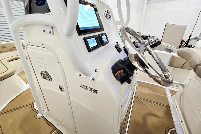 Slide: The Image of 2018 NauticStar 25 XS boat console with steering wheel and digital displays. - 21