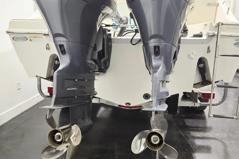 Slide: The Image of 2018 NauticStar 25 XS boat with dual outboard motors, rear view. - 7