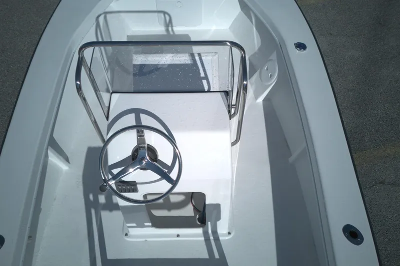 Slide: The Image of 2026 C-Hawk 18 Center Console boat with steering wheel and console view. - 5