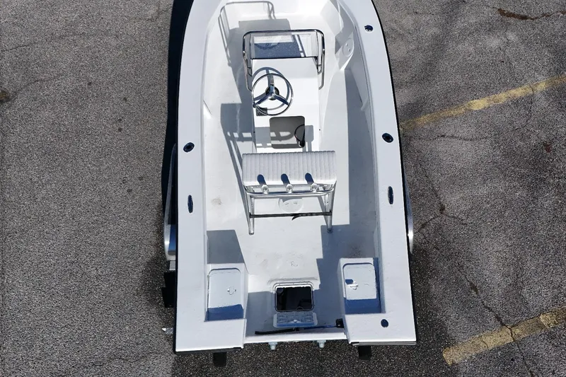 Slide: The Image of 2026 C-Hawk 18 Center Console boat, aerial view, parked on asphalt. - 8