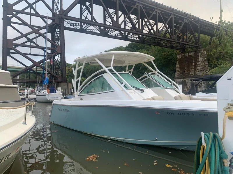 Slide: The Image of 2017 Sailfish 245 DC boat docked under bridge. - 1