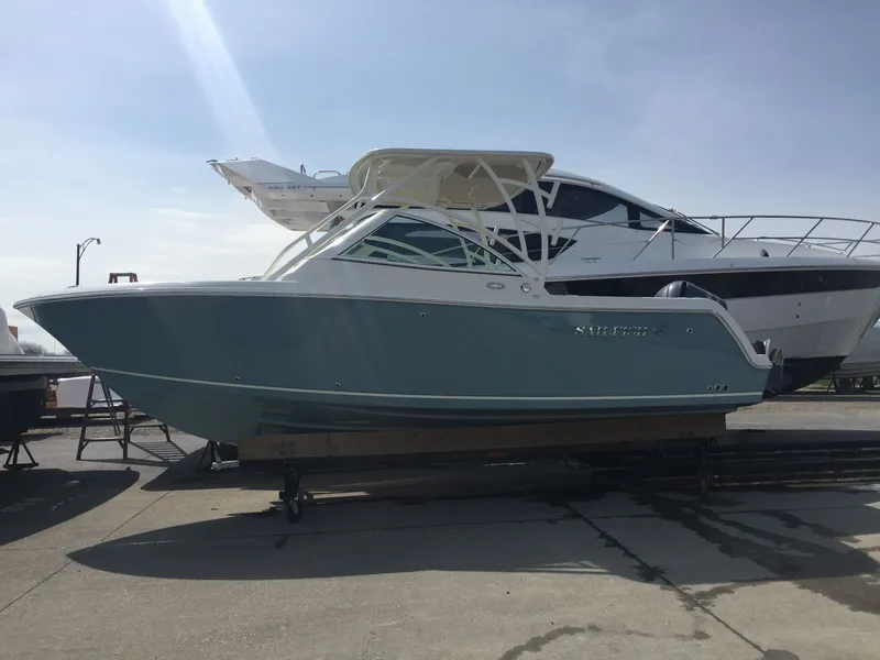 Slide: The Image of 2017 Sailfish 245 DC boat on a trailer outdoors. - 7