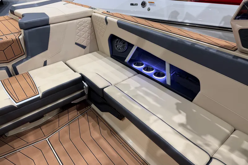 Slide: The Image of 2026 Nautique Super Air Nautique GS24 interior with luxurious seating and illuminated cup holders. - 6