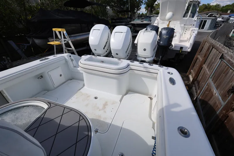 Slide: The Image of 2017 Yellowfin 36 Offshore boat with triple Mercury engines, docked in a yard. - 12