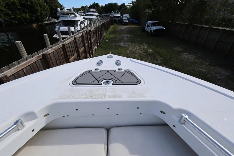 Slide: The Image of 2017 Yellowfin 36 Offshore boat bow view, docked near a wooden fence. - 14