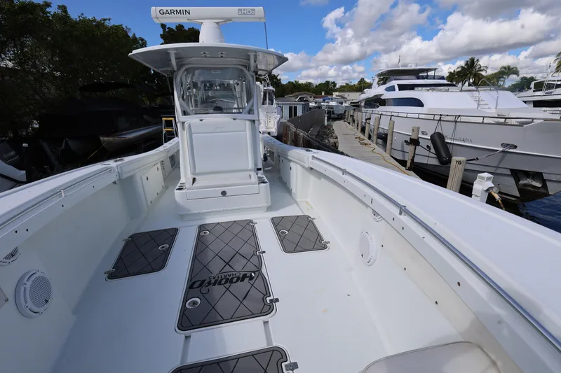 Slide: The Image of 2017 Yellowfin 36 Offshore boat docked, featuring spacious deck and Garmin equipment. - 16