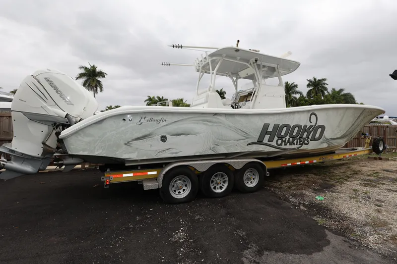 Slide: The Image of 2017 Yellowfin 36 Offshore boat on trailer with "Hooked Charters" branding. - 2