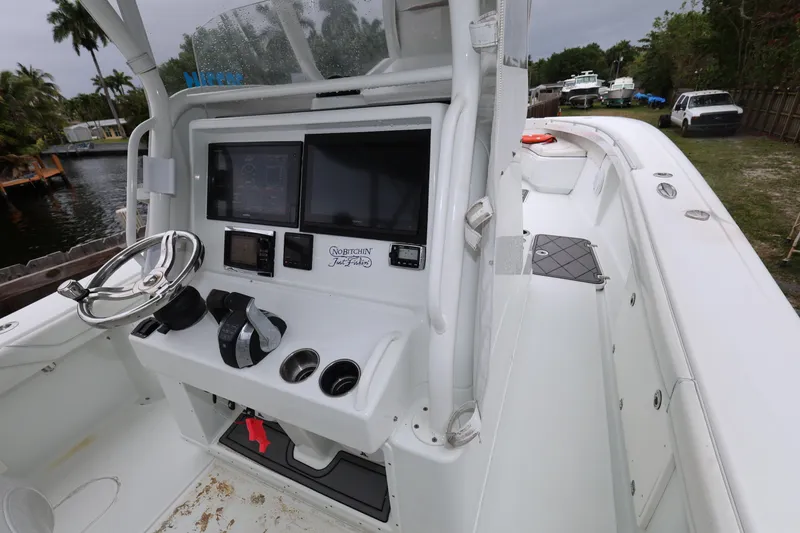 Slide: The Image of 2017 Yellowfin 36 Offshore boat cockpit with steering wheel and navigation screens. - 21