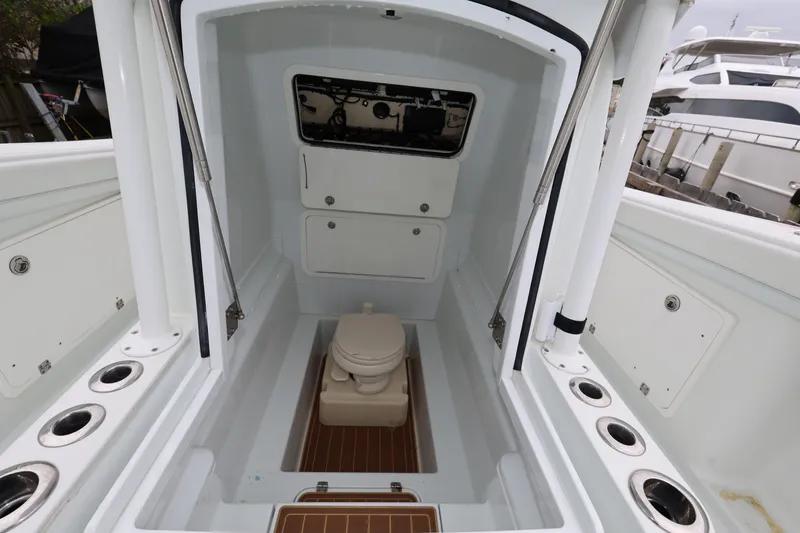 Slide: The Image of 2017 Yellowfin 36 Offshore boat interior with toilet and storage compartments. - 28