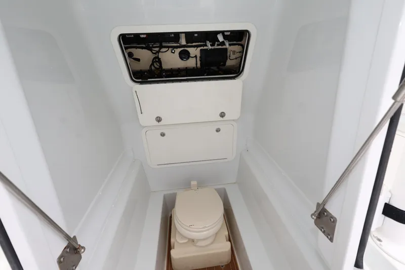 Slide: The Image of 2017 Yellowfin 36 Offshore boat interior with compact marine toilet and storage compartments. - 29