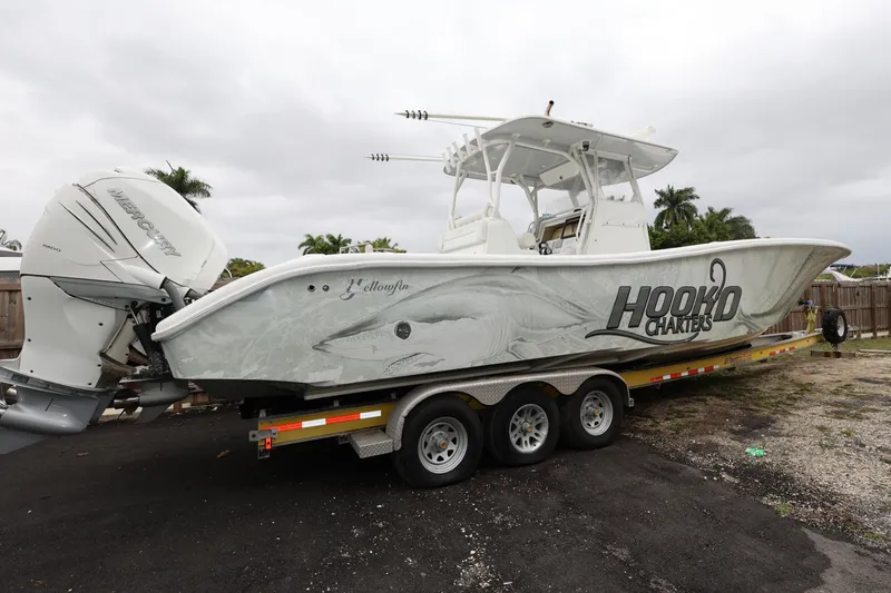 Slide: The Image of 2017 Yellowfin 36 Offshore boat on trailer with Mercury engines, featuring "Hooked Charters" branding. - 3