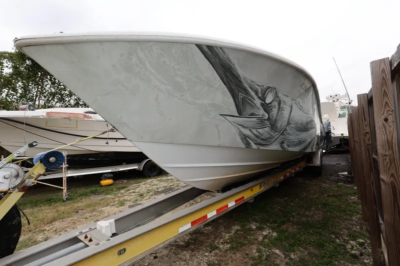 Slide: The Image of 2017 Yellowfin 36 Offshore boat on trailer with marlin artwork on hull. - 7