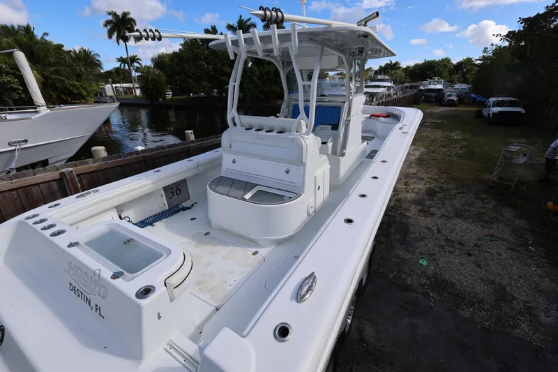 Slide: The Image of 2017 Yellowfin 36 Offshore boat docked near lush greenery and calm waters. - 8