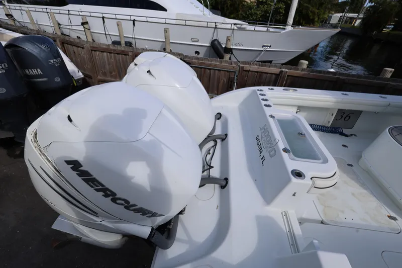 Slide: The Image of 2017 Yellowfin 36 Offshore boat with Mercury outboard engines docked near a marina. - 9