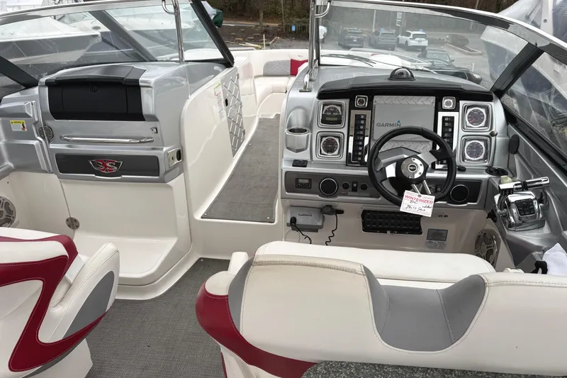 Slide: The Image of Interior view of 2012 Chaparral 327 SSX boat cockpit with steering wheel and controls. - 11