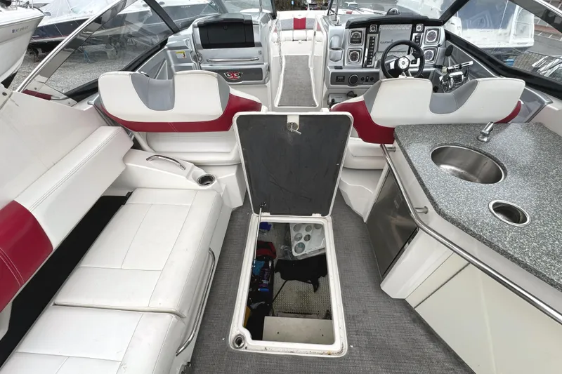 Slide: The Image of Interior of 2012 Chaparral 327 SSX boat with seating, helm, and kitchenette. - 17