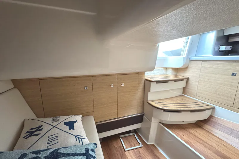 Slide: The Image of Interior of 2012 Chaparral 327 SSX boat with wooden cabinetry and seating area. - 21