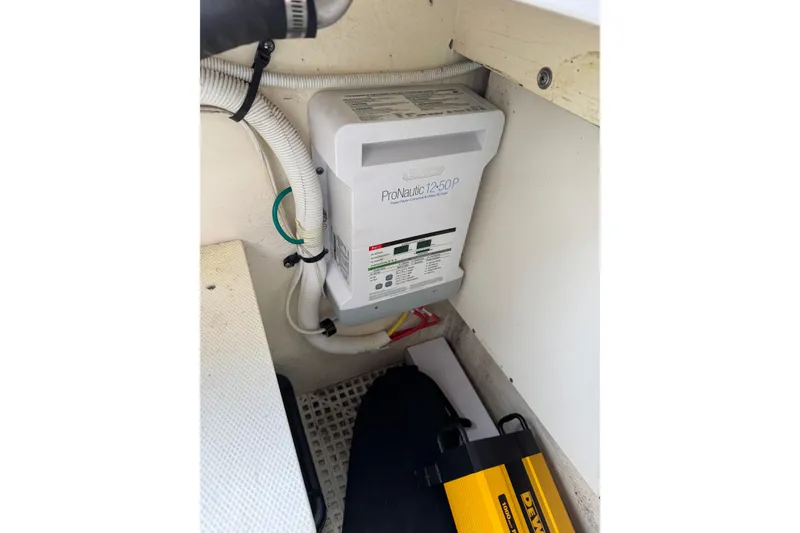 Slide: The Image of Battery charger in 2012 Chaparral 327 SSX boat interior, featuring ProNautic 12-50P model. - 29