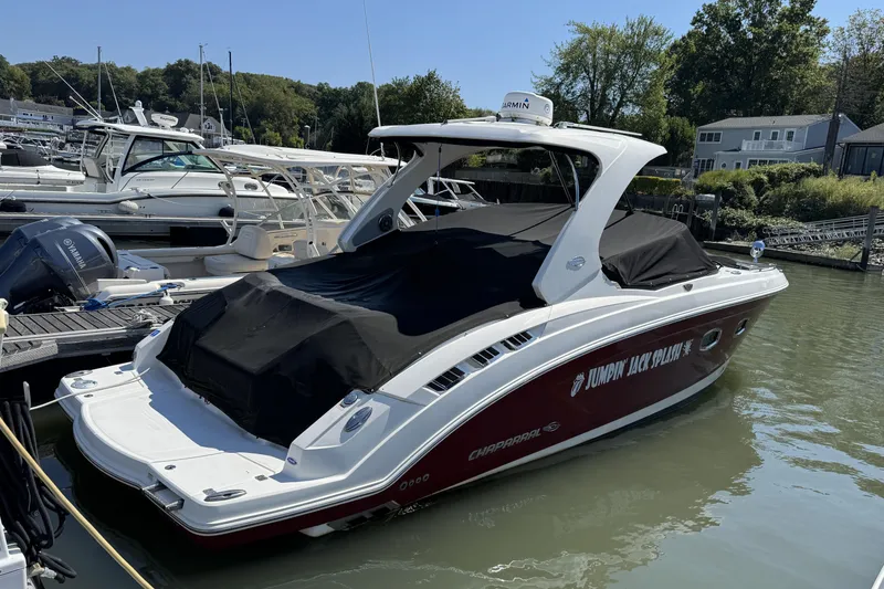 Slide: The Image of 2012 Chaparral 327 SSX boat docked, covered, with "Jumpin' Jack Splash" text on the side. - 3