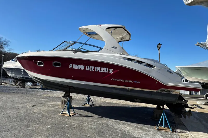 Slide: The Image of 2012 Chaparral 327 SSX boat named "Jumpin' Jack Splash" on stands, side view. - 5