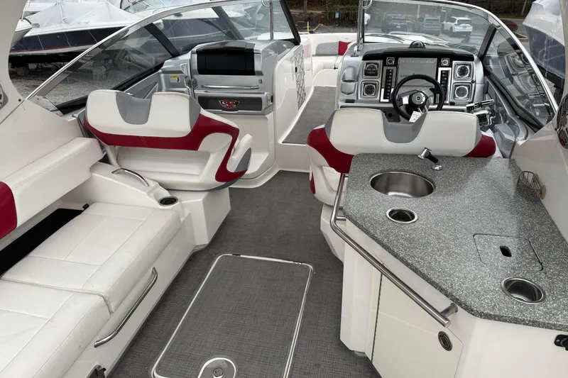 Slide: The Image of 2012 Chaparral 327 SSX boat interior with luxurious seating and modern dashboard. - 8