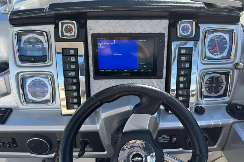 Slide: The Image of Dashboard of a 2012 Chaparral 327 SSX boat with gauges and Garmin display. - 9
