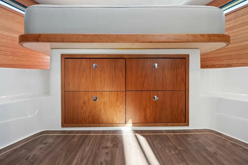 Slide: The Image of Interior of 2026 MJM 47R boat with wooden cabinetry and modern design. - 10