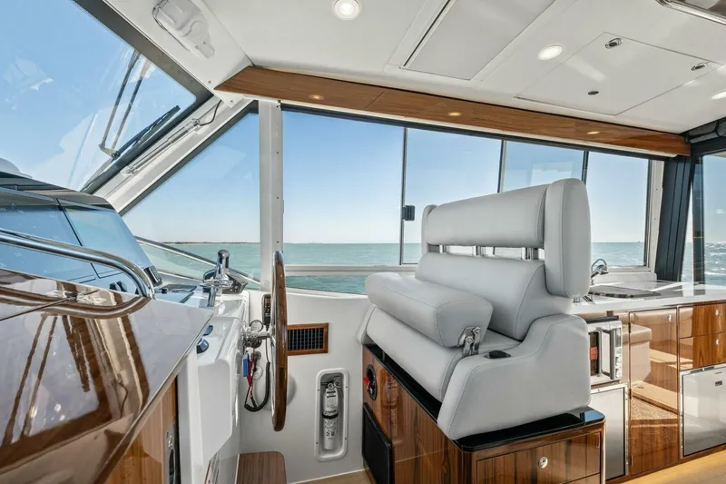 Slide: The Image of Luxurious interior of 2026 MJM 47R yacht with modern helm and ocean view. - 20