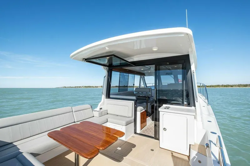 Slide: The Image of Luxury MJM 47R yacht interior, 2026 model, featuring elegant seating and a wooden table. - 26